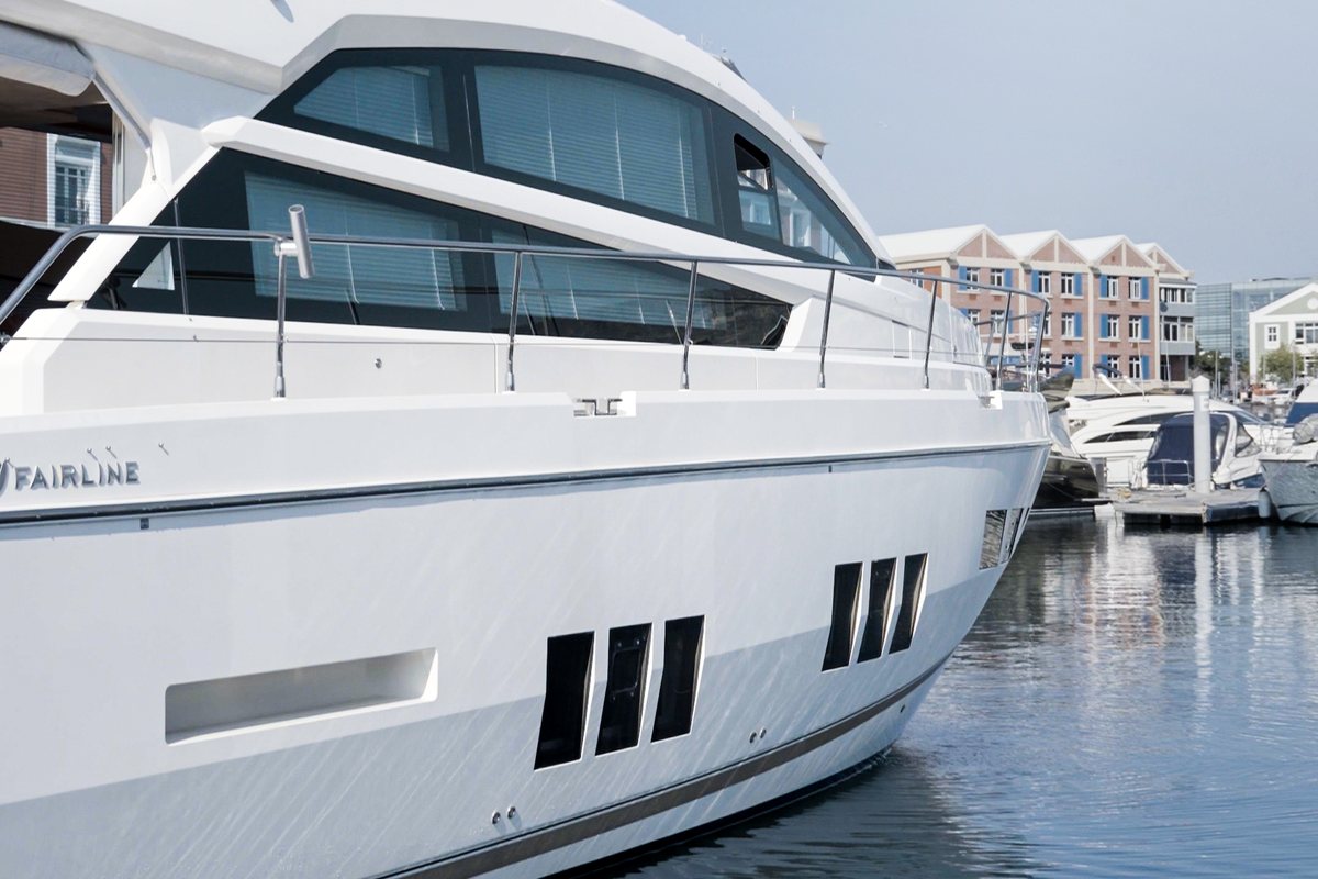 A white Fairline motor yacht moored in a marina
